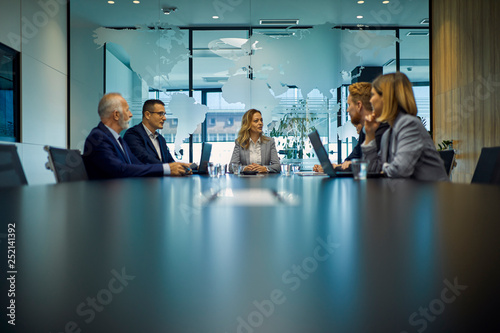 Group of business people discussing in meeting photo