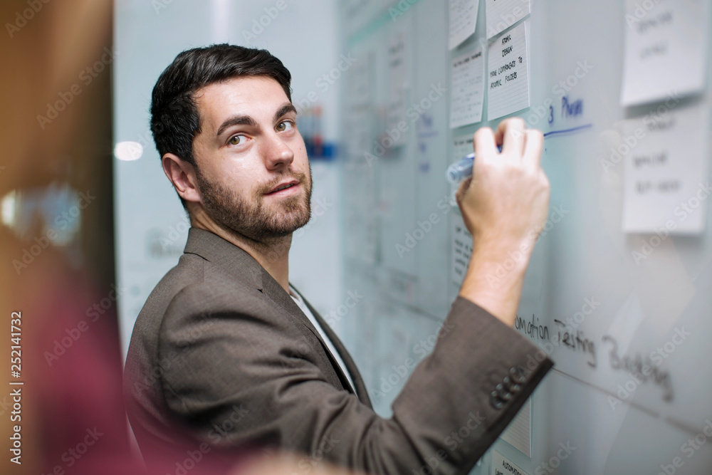 Businessman writing notes on a whiteboard