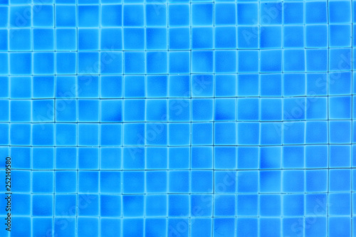 top view square blue tiles under water in swimming pool