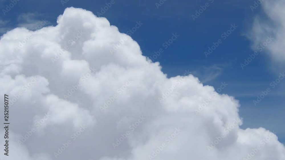 Above the clouds, flying in the air. View of clouds through airplane window.