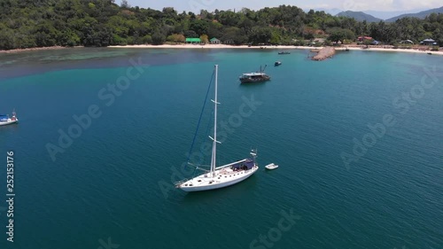 Wallpaper Mural Aerial view 4k footage of white Yacht in deep blue sea with beautiful landscape view in Kuala Abai, Kota Belud, Sabah, Malaysia Torontodigital.ca