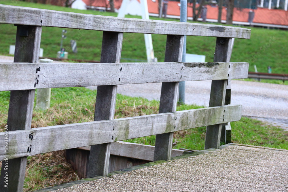 Old wooden balustrade of a small wooden bridge