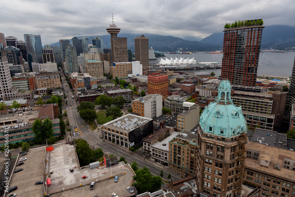 Downtown Vancouver, British Columbia, Canada - June 22, 2018: Aerial view of the modern city during a cloudy sunset.