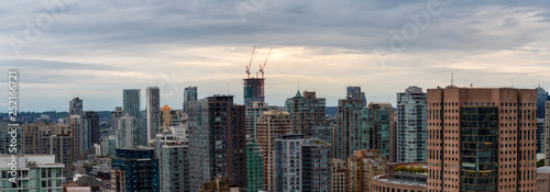 Aerial view of the modern city during a cloudy sunset. Taken in Downtown Vancouver, British Columbia, Canada.