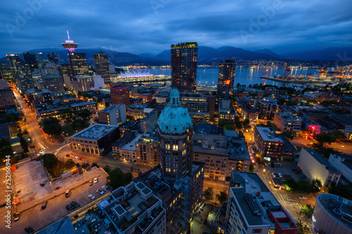 Downtown Vancouver, British Columbia, Canada - June 22, 2018: Aerial view of the modern city during night time after a cloudy sunset.