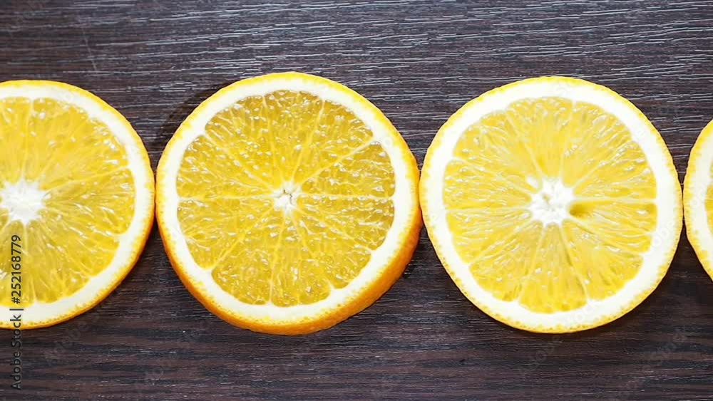 Appetizing orange circles lying on a wooden background. Camera wiring on top. Diet, food, healthy food. Appetizing orange circles lying on a wooden background. Camera wiring on top. Diet, food, healthy food.