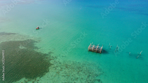 Fish cage and fishing boat on sea