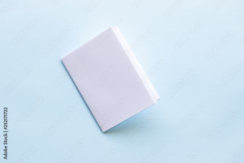 Blank portrait mock-up paper. brochure magazine isolated on blue, changeable background / white paper isolated on light blue paper. Blank portrait mock-up paper. brochure magazine isolated on blue, changeable background / white paper isolated on light blue paper.