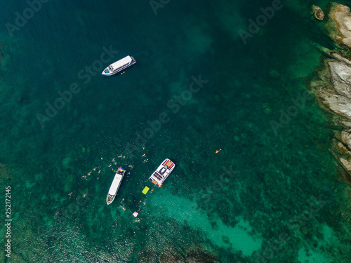 Aerial of cabin cruiser on the big ocean in Andaman take tourist goto snorkeling point at koh mai thon, Phuket, Thailand
