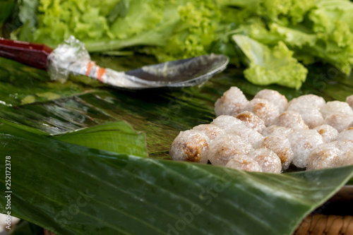 Tapioca balls with pork filling on banana leaf.