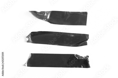 Set of black tapes on white background. Torn horizontal and different size black sticky tape, adhesive pieces. photo