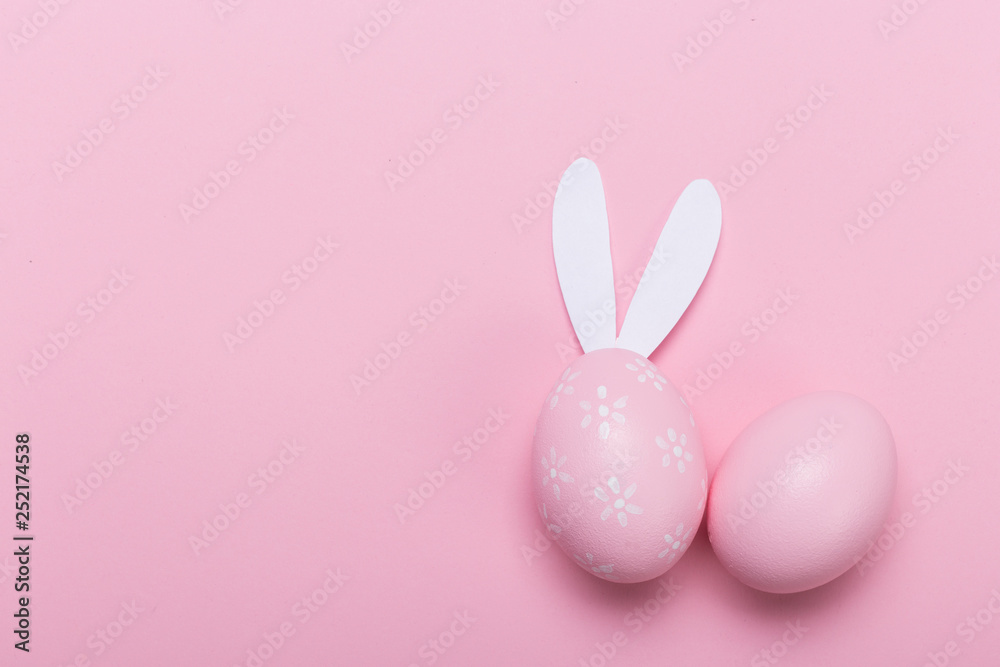 Fototapeta premium Pink easter eggs in nest on pastel color background with space. Concept