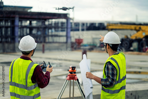 civil engineering flying drone over construction site survey for land and building project.