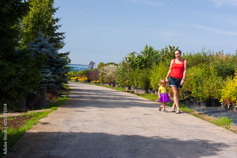 Mother and daughter walking in a park