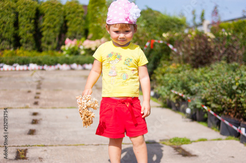 Little girl walking in a sunny park
