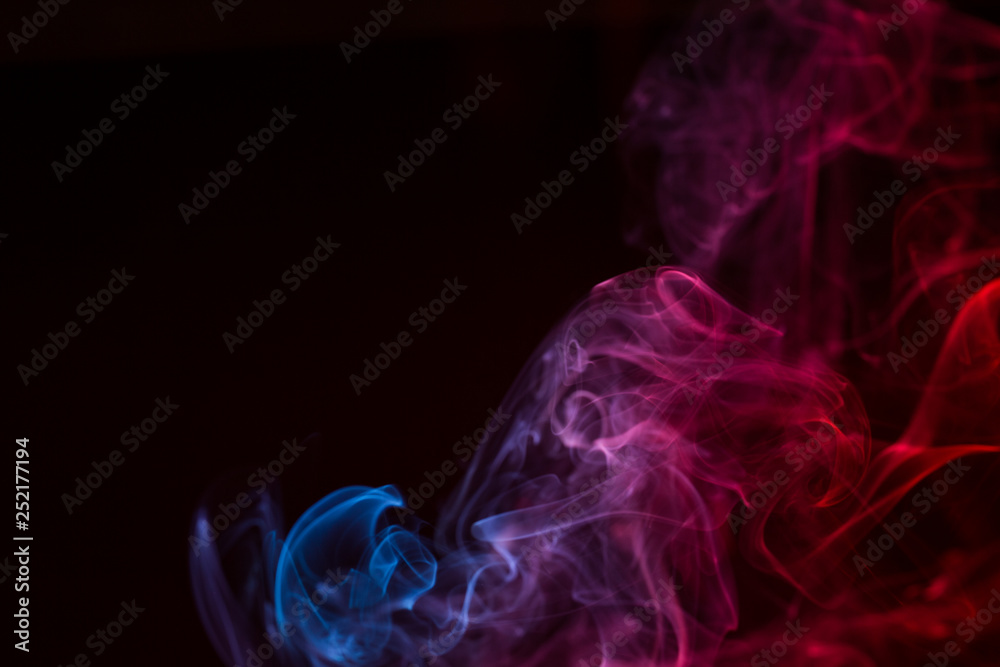 Fototapeta premium Colorful smoke close-up on a black background
