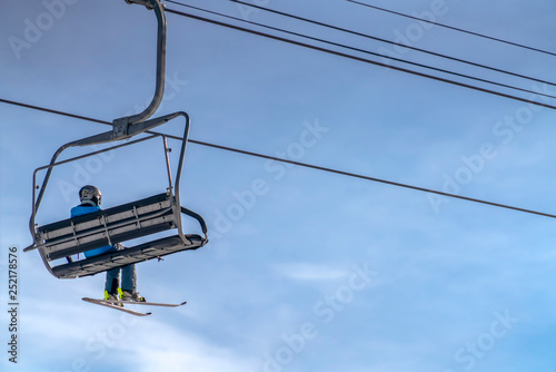 Chair lift with a person in Park City ski resort