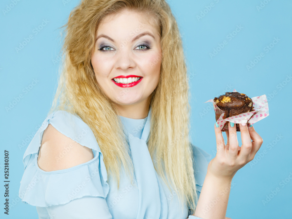 Attractive woman holds cake in hand Attractive woman holds cake in hand