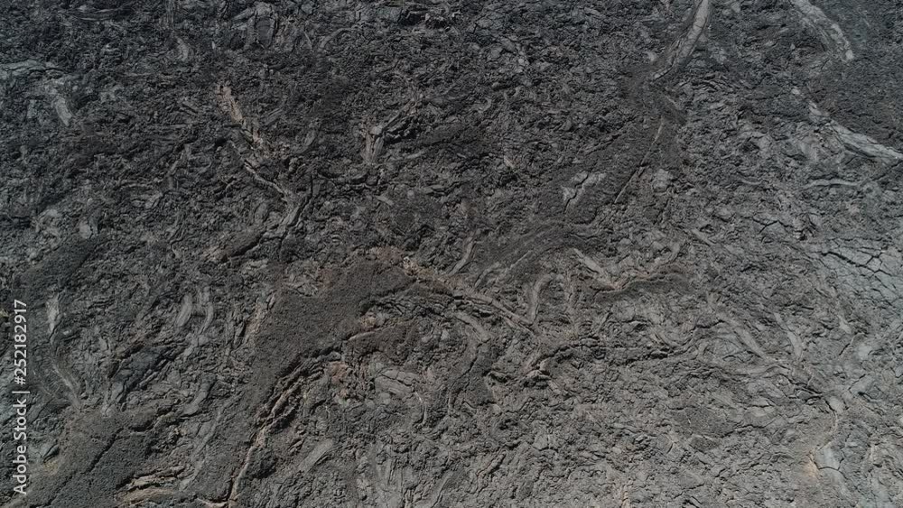 Senital aerial drone scene flying over black bed of lava. Natural volcanic textures, patterns. Antofagasta de la Sierra, Catamarca, Argentina Senital aerial drone scene flying over black bed of lava. Natural volcanic textures, patterns. Antofagasta de la Sierra, Catamarca, Argentina