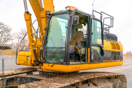 Empty cab of an excavator with soil on grouser pad