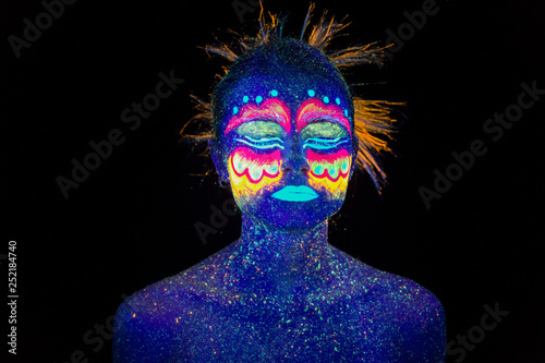 Blue woman portrait, aliens sleeps, ultraviolet make-up.  Beautiful on a dark background. Full face portrait