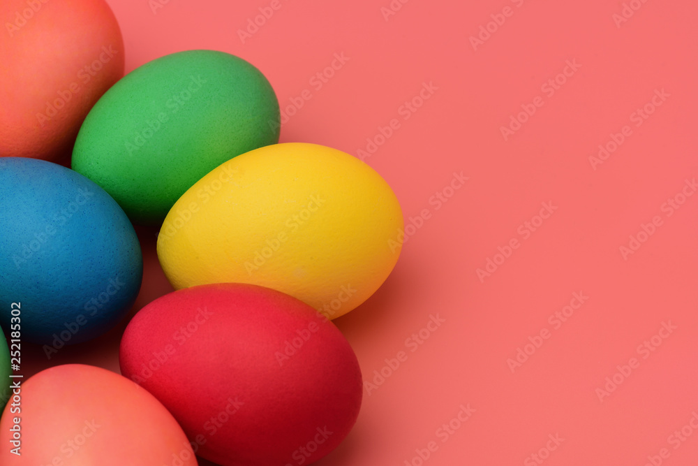 Colorful Easter eggs lie on a pink background. Horizontal photography. Colorful Easter eggs lie on a pink background. Horizontal photography.