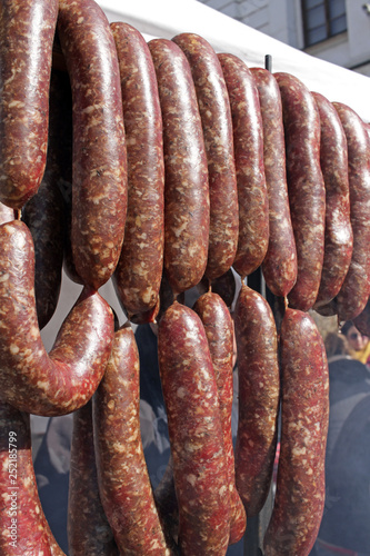 fresh sausages hangs outdoor. fast food on the street. unhealthy food. Smoked sausages salami. 