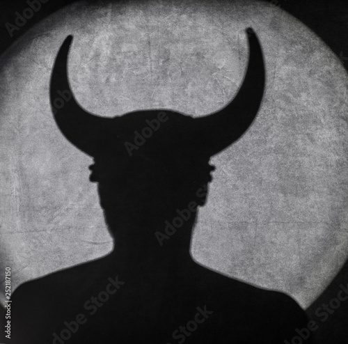Leinwand Poster shadow of a monster with horns, the shadow of the devil