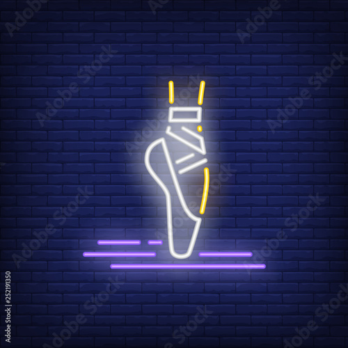 Woman leg wearing pointe ballet shoe neon sign