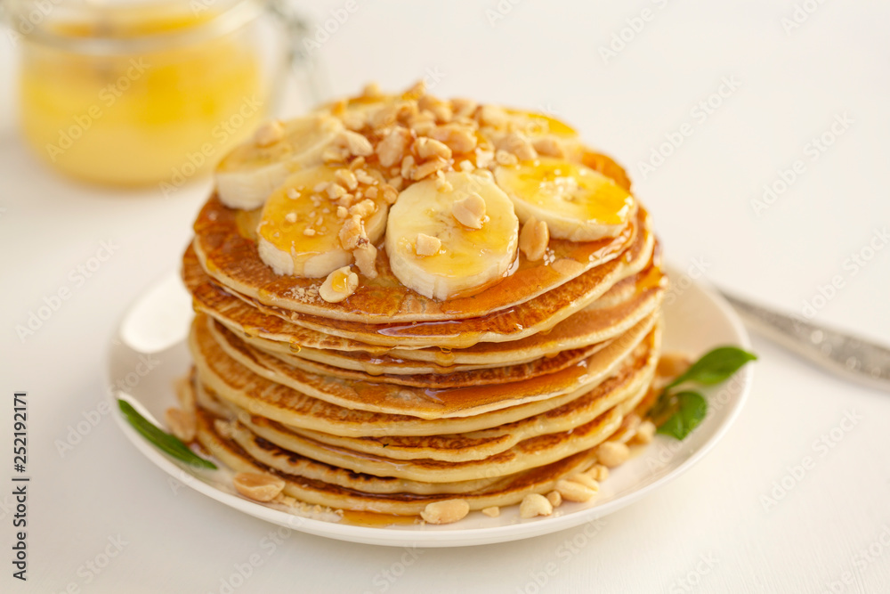 Sweet Homemade Stack of Pancakes with banana, nuts and honey. Delicious breakfast. Sweet Homemade Stack of Pancakes with banana, nuts and honey. Delicious breakfast.