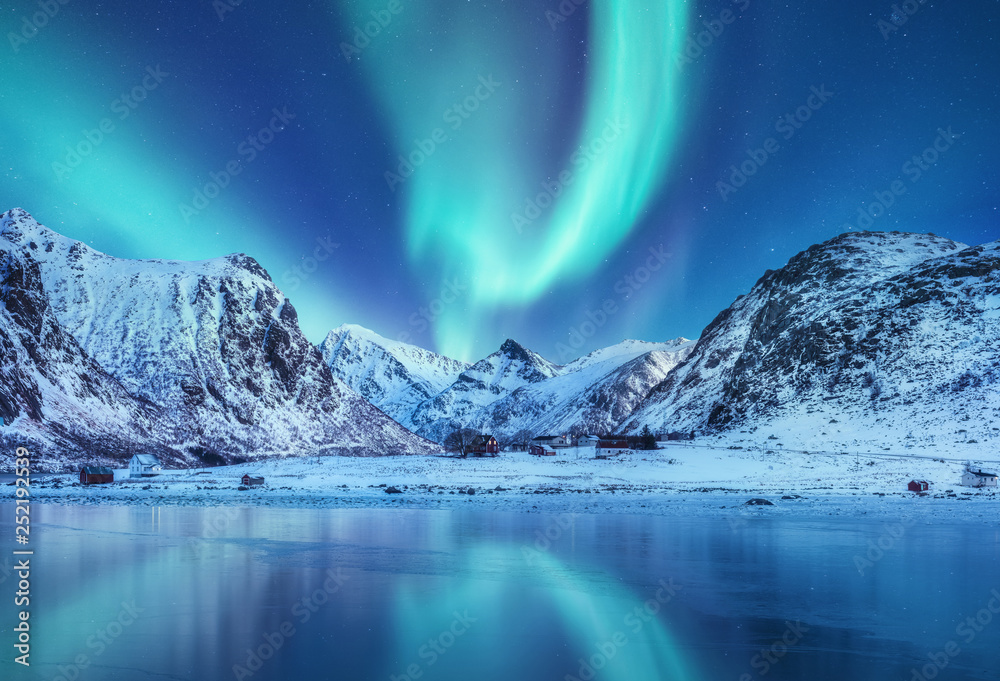 Aurora borealis on the Lofoten islands, Norway. Green northern lights above mountains. Night sky with polar lights. Night winter landscape with aurora and reflection on the water surface. Norway-image