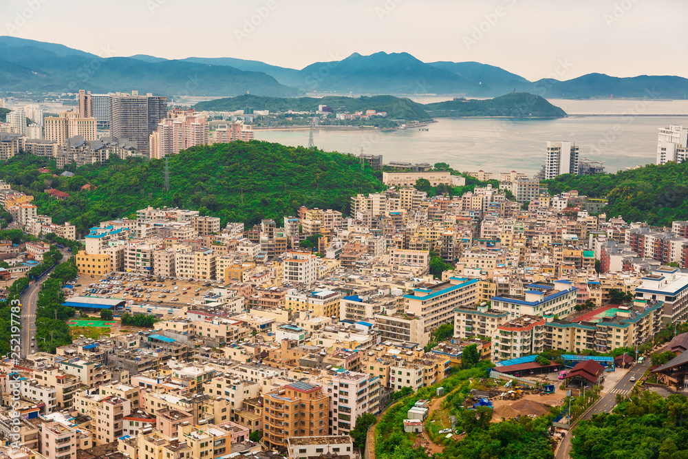 Fototapeta premium Beautiful Panoramic view of the resort city, China, Hainan. Town Sanya is popular tourist destination in China. Residential area of city Sanya, ashore South China Sea
