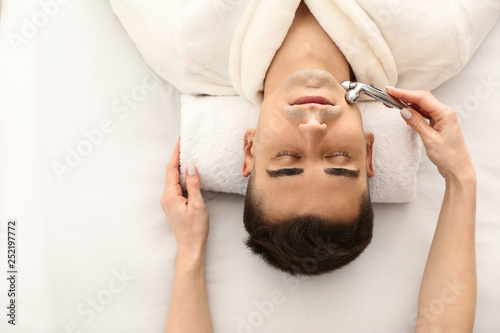Man receiving face massage ...