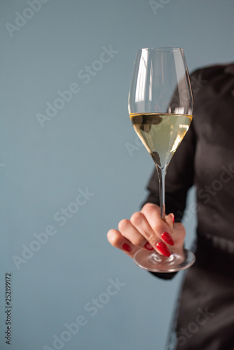 Woman holding a wine glass with wine in hand. Copy space