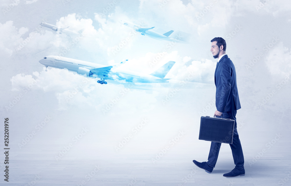 Elegant businessman going somewhere with briefcase and airplane on the background
Elegant businessman going somewhere with briefcase and airplane on the background