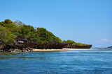 View of coastline with beach. Sea or ocean with boat and blue sky. Kenya