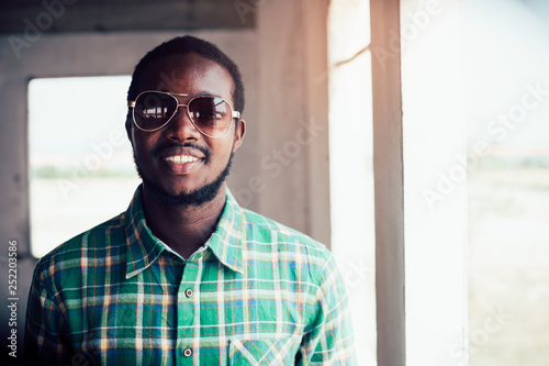 Portrait of smile bearded African man wearing sunglasses