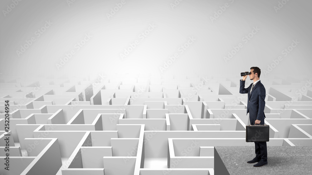 Businessman standing on maze and looking forward to the future concept

