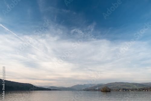 A wide shot of the head of Windermere from a boat, Wansfell Pike and the Fairfield Horseshoe are seen in the distance, Lake District, UK