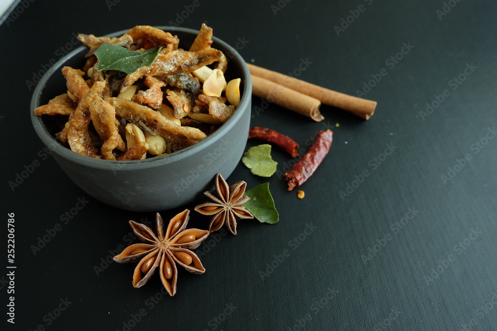 Fototapeta premium Fried fish with herbs and nuts. Appetizer Thai food. 