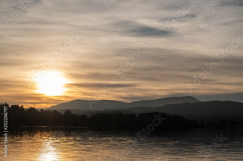 Sunset over Consiton Old Man and Wetherlam, seen over Windermere, Lake District, UK