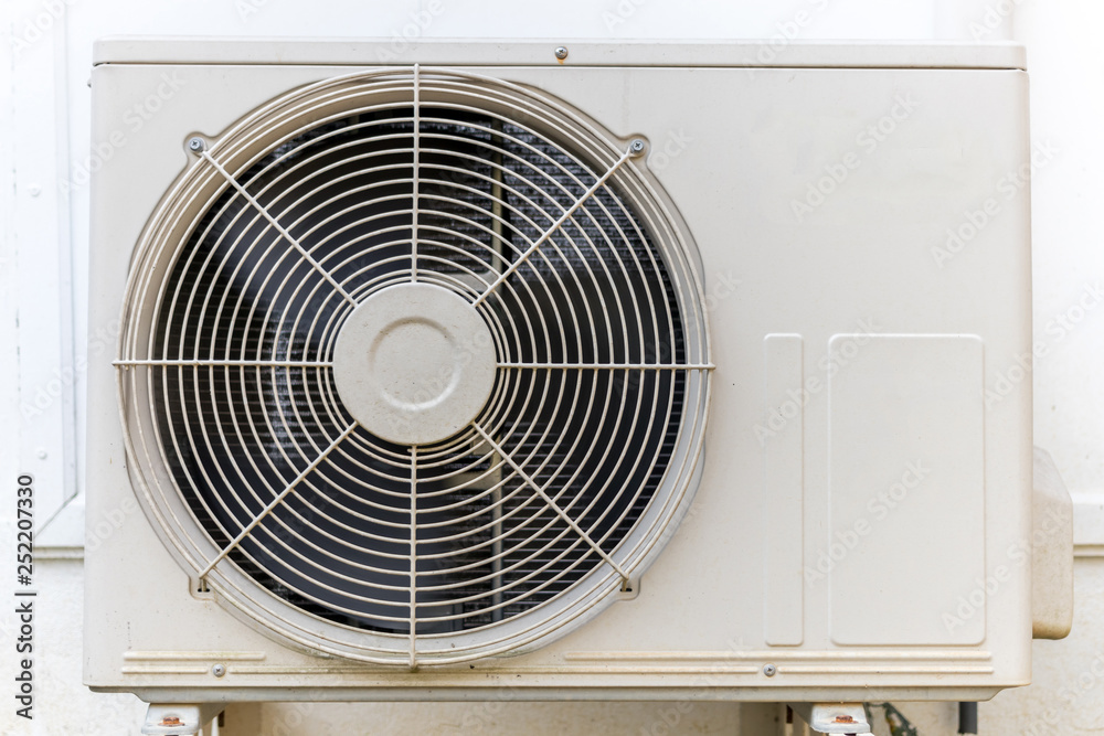 Condenser air conditioner compressor unit on concrete wall. Condenser air conditioner compressor unit on concrete wall.