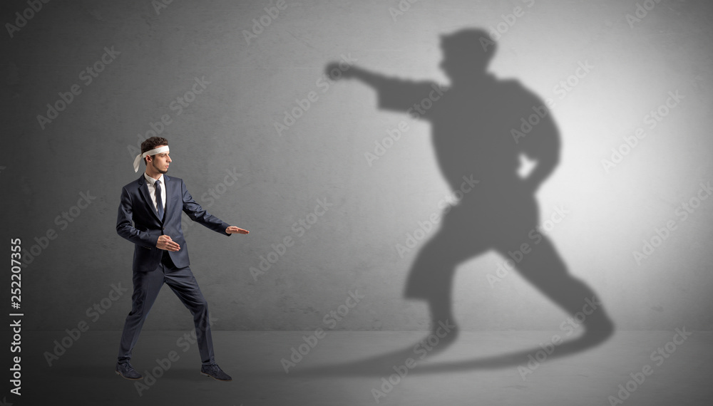 Young karate man confronting with his own shadow
Young karate man confronting with his own shadow