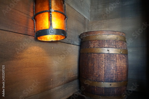 Orange yellow lamp and beer barrel inside bar wooden wall vintage decoration cowboy 