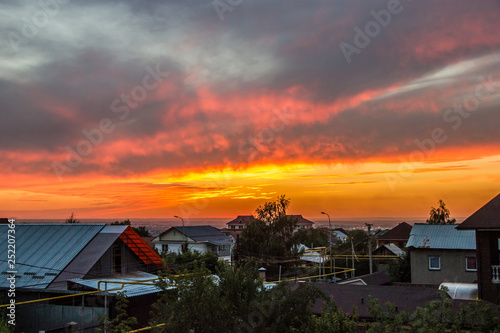 Colorful Summer Sunset over Houses