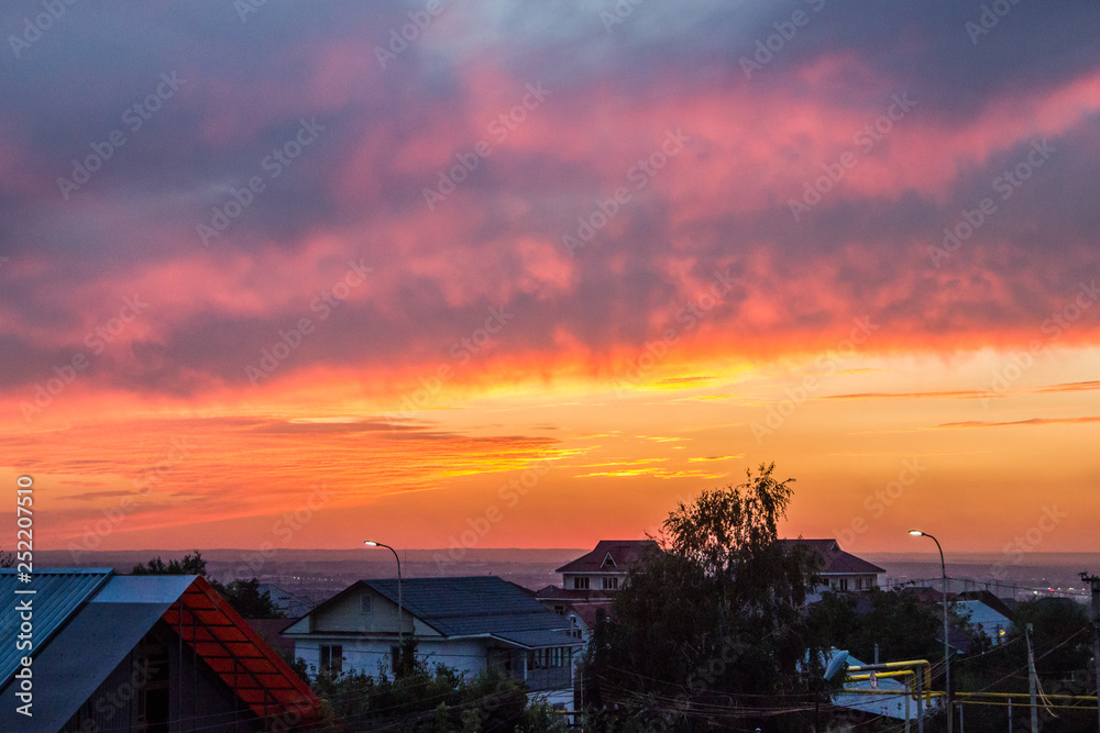 Colorful Summer Sunset over Houses