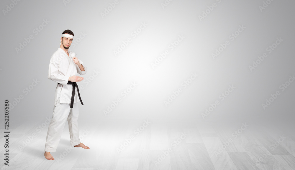 Young kung-fu trainer fighting in an empty space
