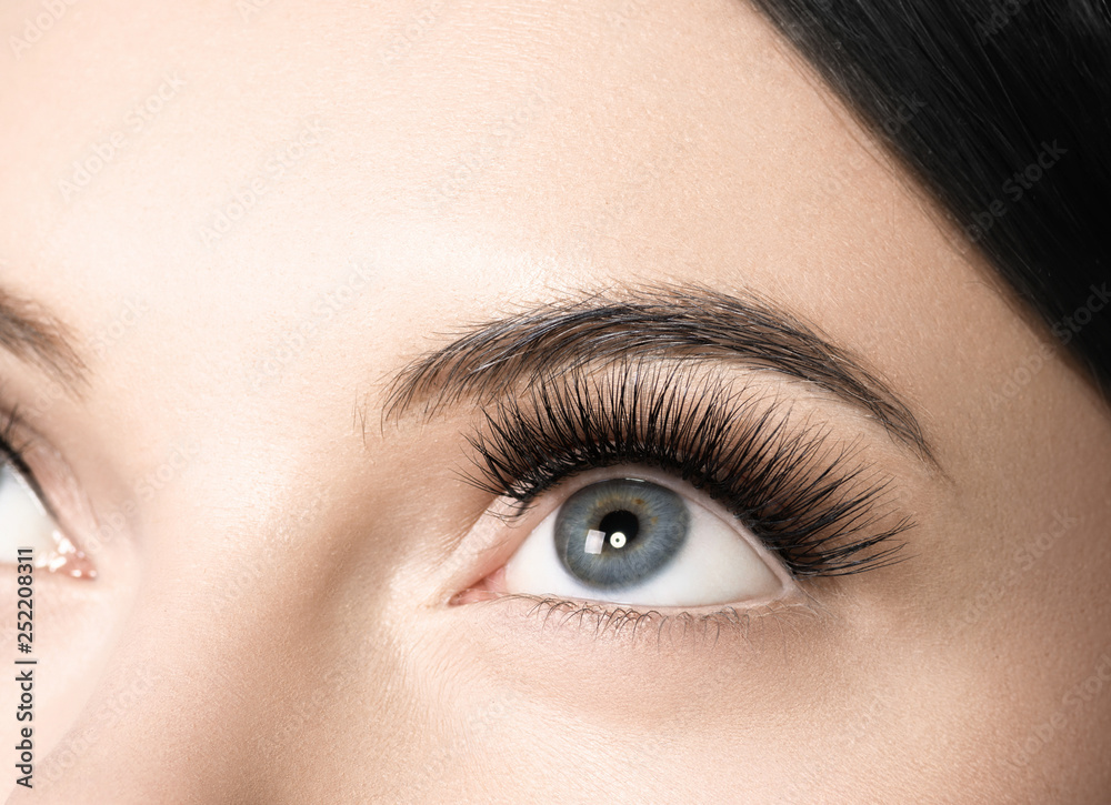 Fototapeta premium Eyes lashes woman closeup isolated on white macro