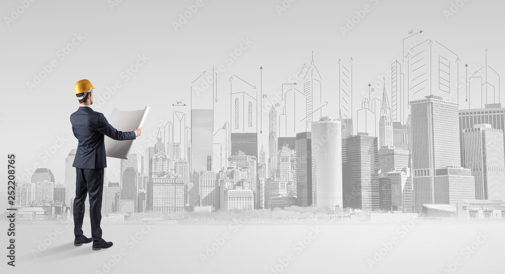 Young supervisor architect standing and replanning a big city panorama
Young supervisor architect standing and replanning a big city panorama