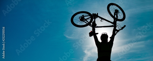 Mountain bike man outdoor with dramatic sky scenery. Sun salutation